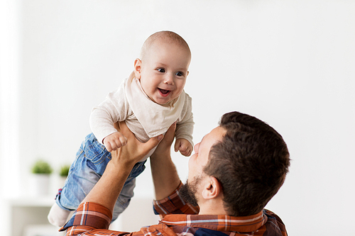 family, childhood, babyhood and people concept - happy little baby boy with father at home