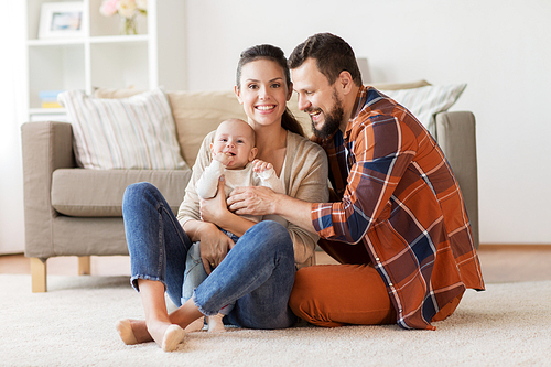 family, parenthood and people concept - happy mother, father and baby at home