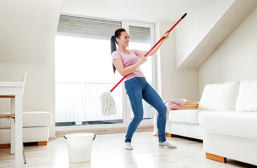 people, housework and housekeeping concept - happy woman or housewife with mop cleaning floor and having fun at home