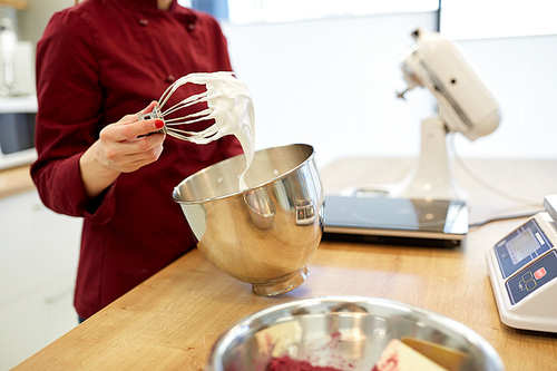 cooking, food and people concept - chef with whisk and whipped egg whites at kitchen