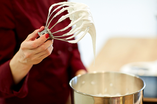 cooking, food and people concept - chef with whisk and whipped egg whites at kitchen