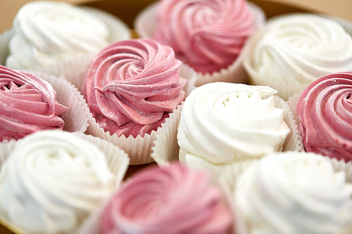 food, confection and sweets concept - close up of zephyr or marshmallow dessert on plate