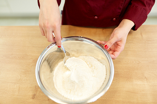 cooking food, baking and people concept - chef with flour in bowl making batter or dough