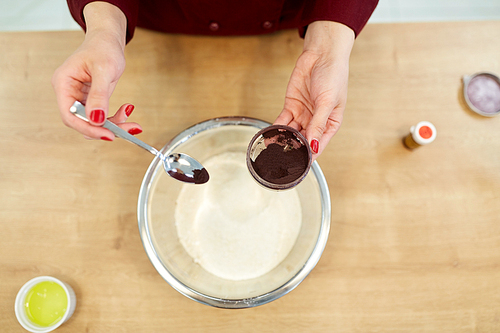 cooking, baking and people concept - chef hands with flour in bowl and food color additive making batter or dough