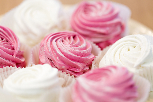 food, confection and sweets concept - close up of zephyr or marshmallow dessert on plate