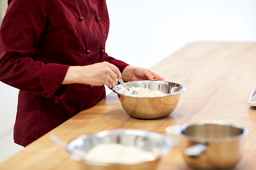 cooking food, baking and people concept - chef with flour in bowl making batter or dough