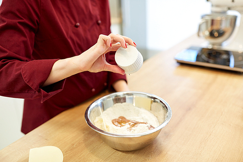 cooking food, baking and people concept - chef pouring egg whites into flour in bowl and making batter or dough