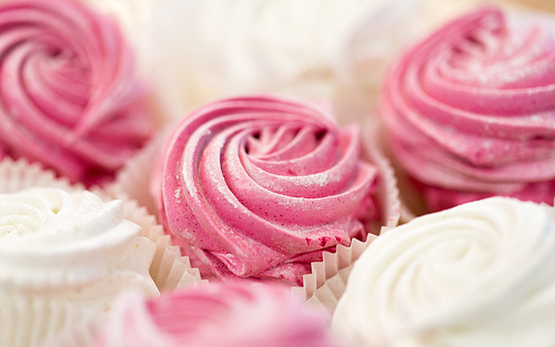 food, confection and sweets concept - close up of zephyr or marshmallow dessert on plate