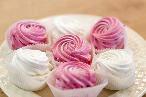 food, confection and sweets concept - zephyr or marshmallow dessert on plate