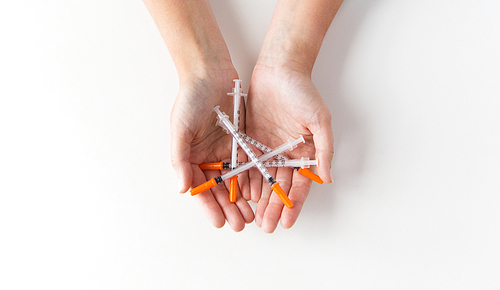 medicine, diabetes, health care and people concept - close up of woman hands holding syringes