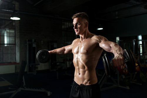 sport, bodybuilding, fitness and people concept - close up of young man with dumbbells flexing muscles in gym