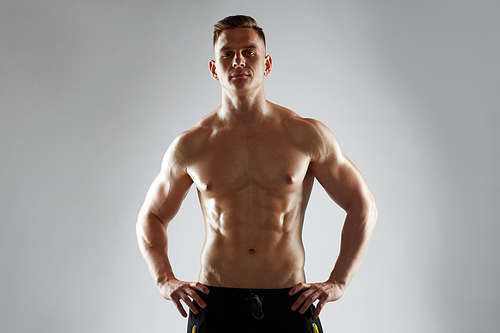 sport, bodybuilding, fitness and people concept - young man or bodybuilder with bare torso