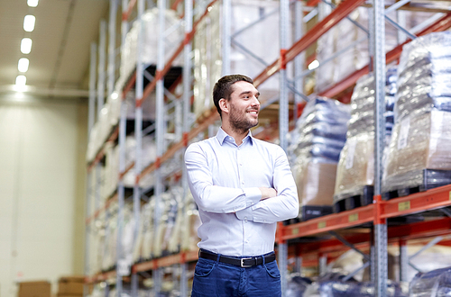 wholesale, logistic, business, export and people concept - happy man at warehouse