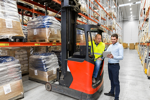 logistic business, technology and people concept - loader on forklift and businessman with tablet pc computer at warehouse