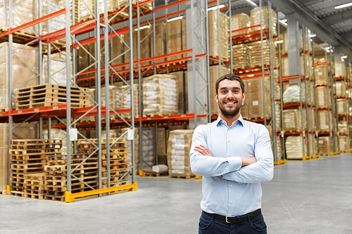 logistic business, shipment and people concept - happy businessman at warehouse