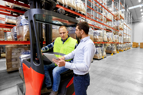 logistic business, shipment and people concept - warehouse worker and businessman with tablet pc computer and tablet pc computer