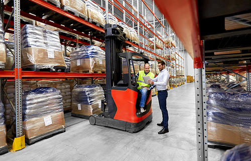 logistic business, shipment and people concept - warehouse worker and businessman with tablet pc computer and tablet pc computer