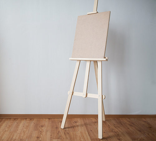 fine art, creativity and artistic tools concept - wooden easel at studio