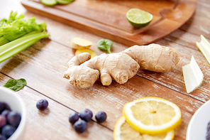 healthy eating, food and diet concept - ginger with fruits, berries and vegetables on table