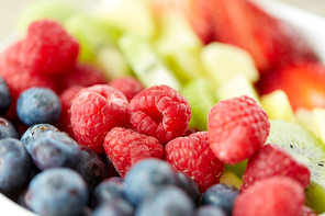 healthy eating and food concept - close up of fruits and berries