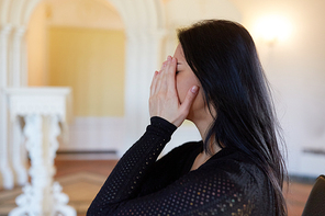 burial, people and mourning concept - crying unhappy woman at funeral in church