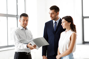 real estate business, sale and people concept - happy smiling realtor with folder showing documents to customers at new office room