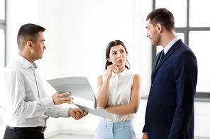 real estate business, sale and people concept - happy smiling realtor with folder showing documents to customers at new office room