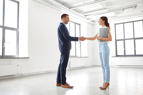 business people, partnership and cooperation concept - happy smiling businesswoman with folder and businessman shake hands at office