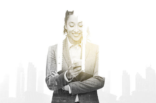 business, people and technology concept - smiling african american businesswoman looking at smartphone over city buildings and double exposure effect