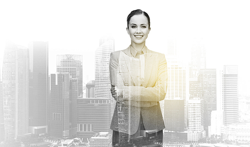 business, people and corporate concept - smiling businesswoman over city buildings background and double exposure effect