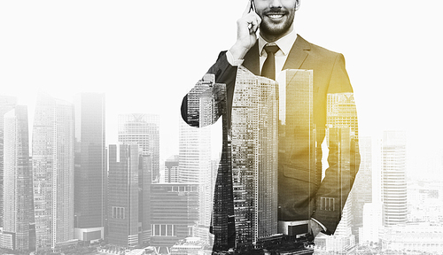 business, technology and people concept - smiling businessman calling on smartphone over city buildings and double exposure effect