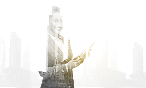 business, people and technology concept - smiling african american businesswoman with tablet pc computer over city buildings and double exposure effect