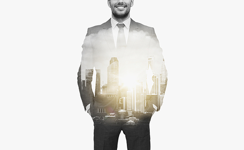 business and people concept - close up of businessman in suit over city buildings and double exposure effect
