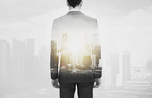business and people concept - close up of businessman in suit from back over city buildings and double exposure effect