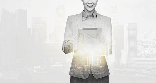 business, people and technology concept - smiling businesswoman with tablet pc computer over city buildings and double exposure effect