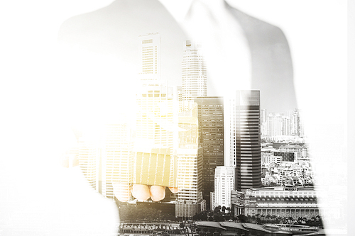 business and people concept - close up of businessman holding gift box over city with double exposure