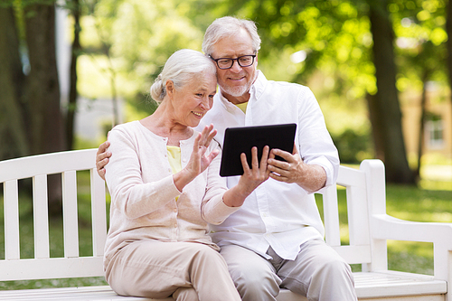 old age, technology and people concept - happy senior couple with tablet pc computer having video chat at summer park