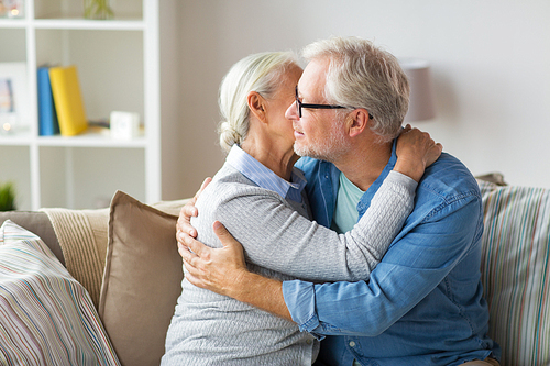 relationships, old age and people concept - happy senior couple hugging at home