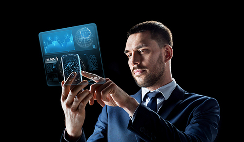 business, augmented reality and future technology concept - businessman working with transparent smartphone and virtual screens projections over black background
