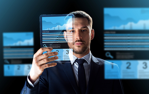 business, augmented reality and future technology concept - businessman in suit working with transparent tablet pc computer and virtual exchange charts projections over black background