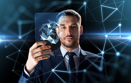 business, augmented reality and future technology concept - businessman in suit working with transparent tablet pc computer and virtual low poly shape projection over black background