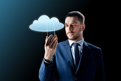 business, augmented reality and future technology concept - businessman in suit working with transparent smartphone and cloud computing hologram over black background