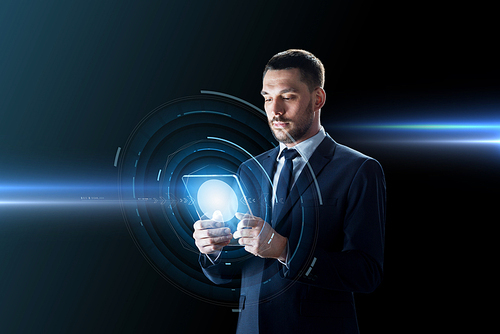 business, augmented reality and future technology concept - businessman in suit working with transparent tablet pc computer and hologram over black background