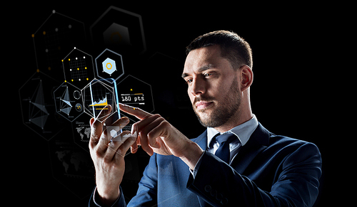 business, augmented reality and future technology concept - businessman working with transparent smartphone and virtual screens projections over black background