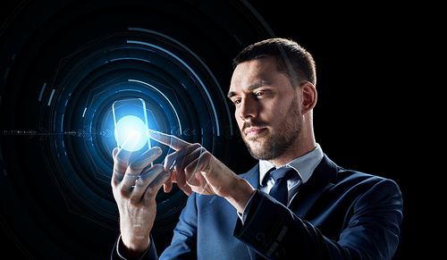 business, augmented reality and future technology concept - businessman in suit working with transparent smartphone and hologram over black background