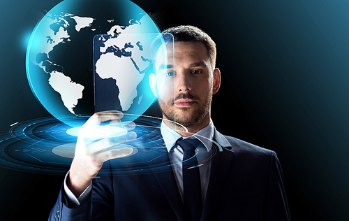 business, augmented reality and future technology concept - businessman in suit working with transparent tablet pc computer and virtual earth globe hologram over black background