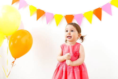 childhood, people and celebration concept - happy baby girl on birthday party