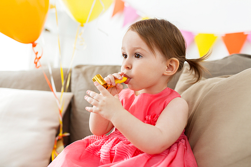 childhood, people and celebration concept - happy baby girl on birthday party at home