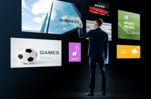 business, people and technology concept - businessman in suit working with virtual applications over black background