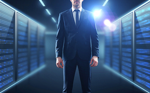 business, people and technology concept - businessman in suit over server room background